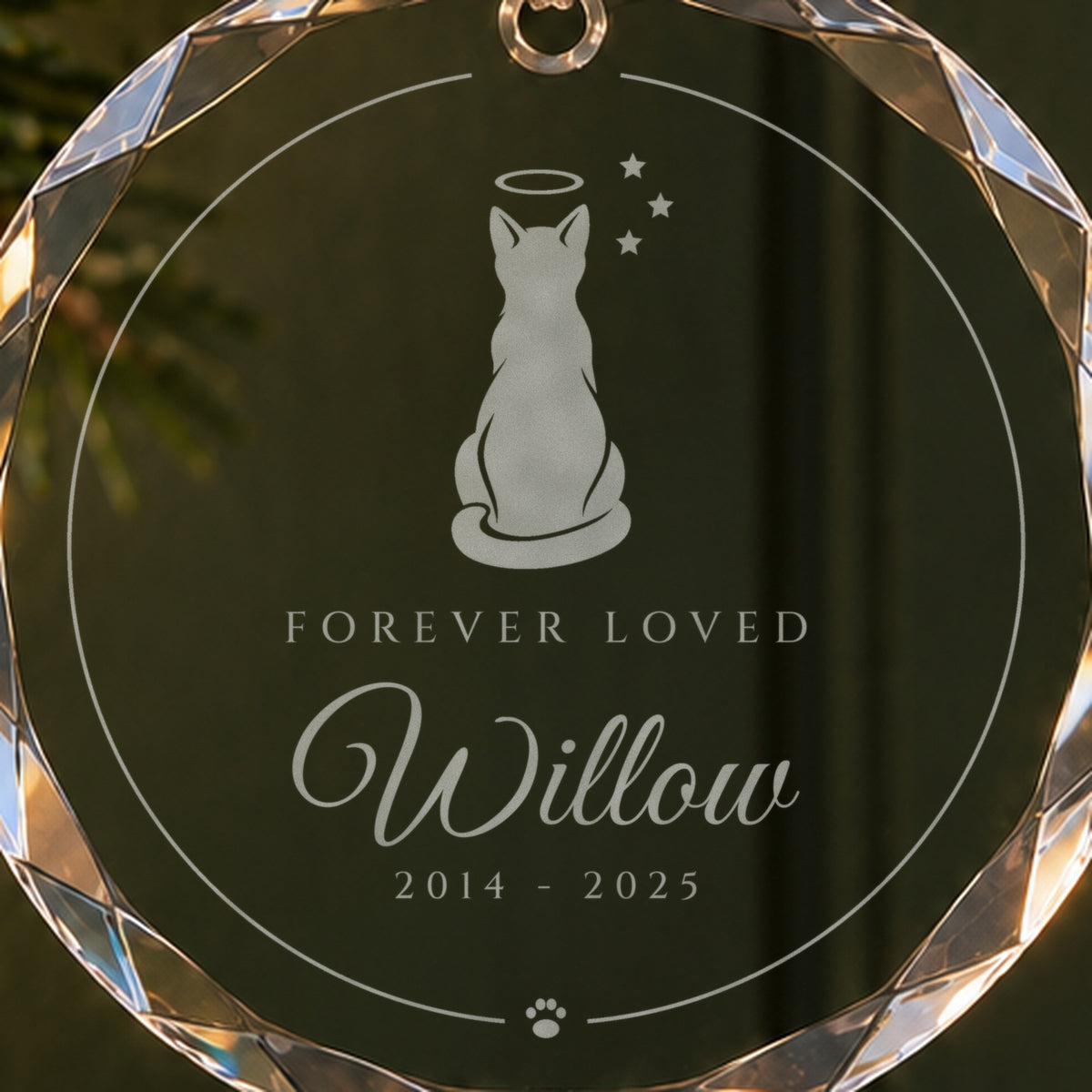 Close-up of the frosted cat engraving with a halo and stars on the memorial Christmas ornament, Forever Loved, Willow