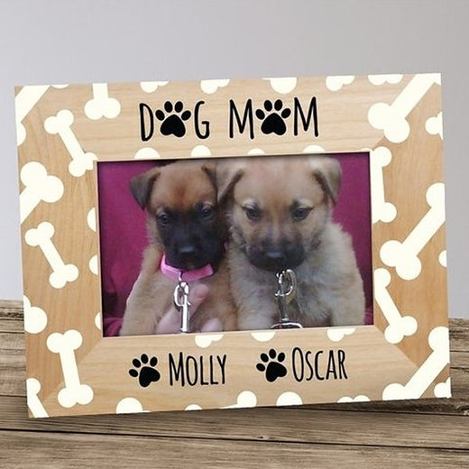Personalized dog mom picture frame in light wood with a cream bone pattern, DOG MOM lettering with paw prints and two pet names printed below the photo
