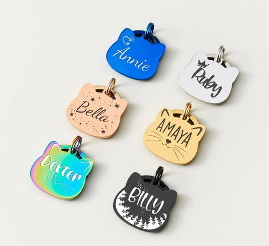 Personalized cat ID tags in small silent designs suited to breakaway cat collars, engraved with a pet name and phone number to get a lost cat home