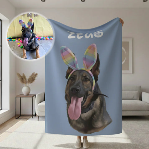 Blue sherpa blanket featuring a personalized dog portrait with rainbow bunny ears and sample name "Zeus" at top, displayed in home setting with circular inset showing reference photo of black dog with colorful props.