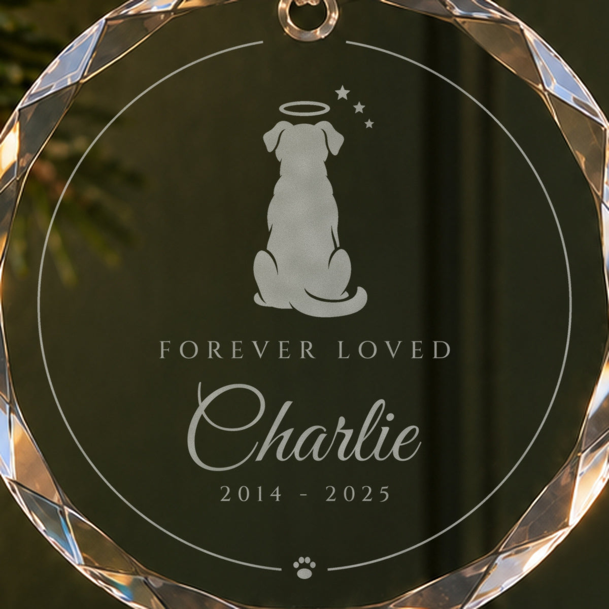 Close-up of the frosted dog engraving with a halo and stars on the memorial Christmas ornament, Forever Loved, Charlie