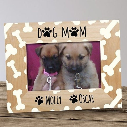 Personalized dog mom picture frame in light wood with a cream bone pattern, DOG MOM lettering with paw prints and two pet names printed below the photo