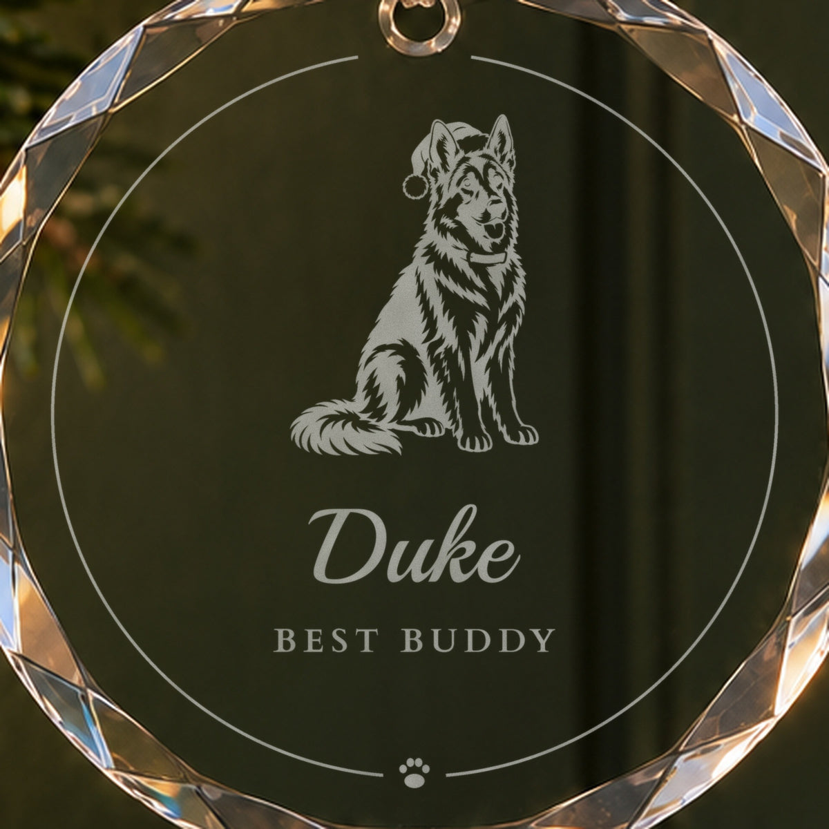 Close-up of the frosted engraving on a personalized dog Christmas ornament: a German shepherd in a Santa hat above the name Duke and Best Buddy
