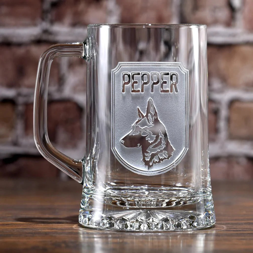Empty Top Dog beer mug in front of a brick wall showing the frosted sand carved shield with a German Shepherd and the name Pepper