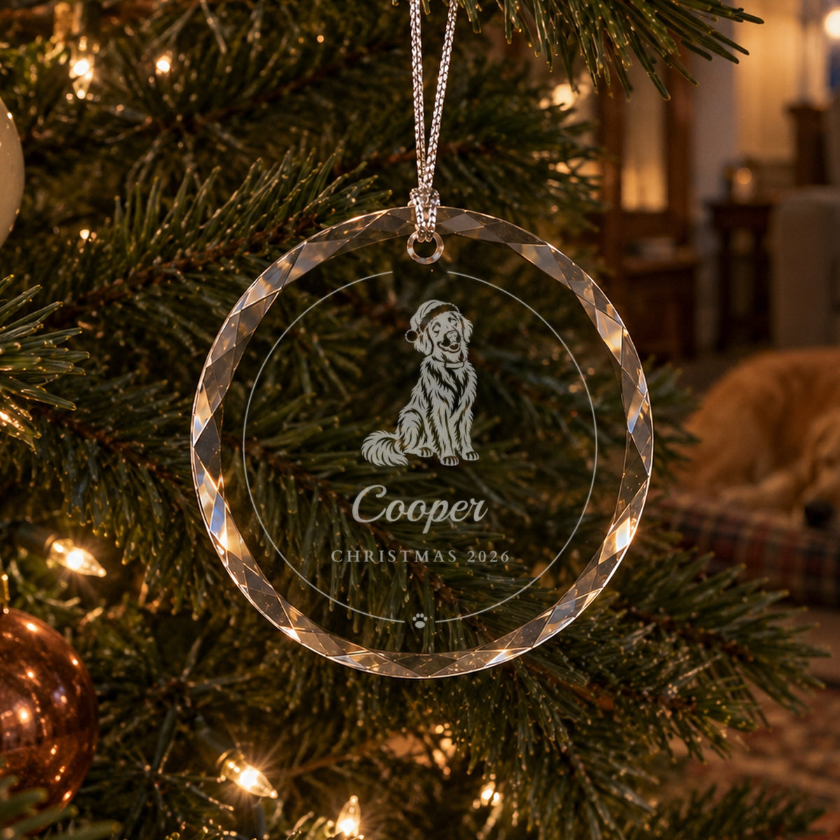 Personalized dog Christmas ornament in clear faceted glass on a lit tree, engraved with a golden retriever in a Santa hat, Cooper and Christmas 2026