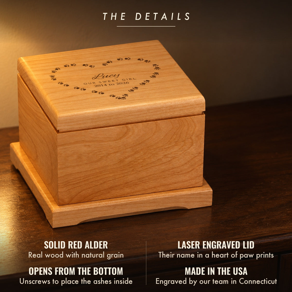 Details of the paw print pet urn: solid red alder, a laser engraved lid reading Lucy, Our Sweet Girl, 2014 to 2026, opens from the bottom, made in the USA